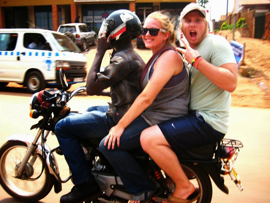 Two tourists enjoying a boda boda ride.
